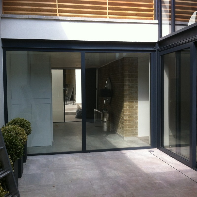 Floor-to-ceiling sliding doors opening to courtyard in Pimlico