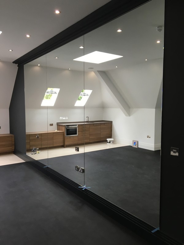 Frameless glass partition in loft conversion by Pimlico glaziers