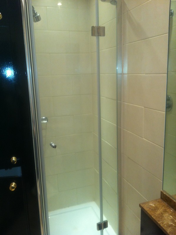 Frameless glass shower enclosure with chrome fittings in Pimlico