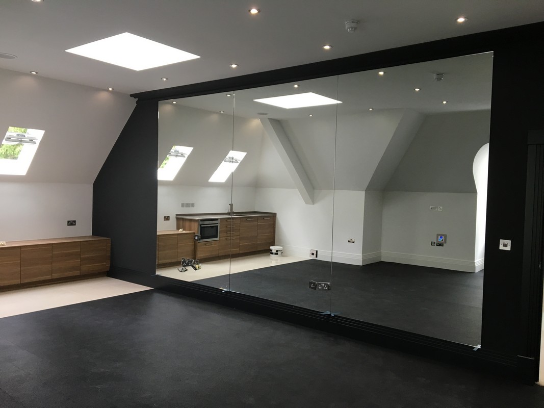 Frameless glass wall dividing loft conversion in Pimlico