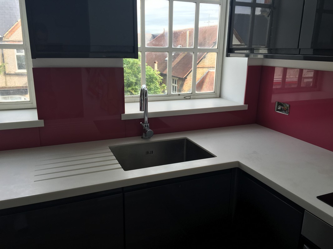 Deep plum coloured glass splashback in modern Pimlico kitchen